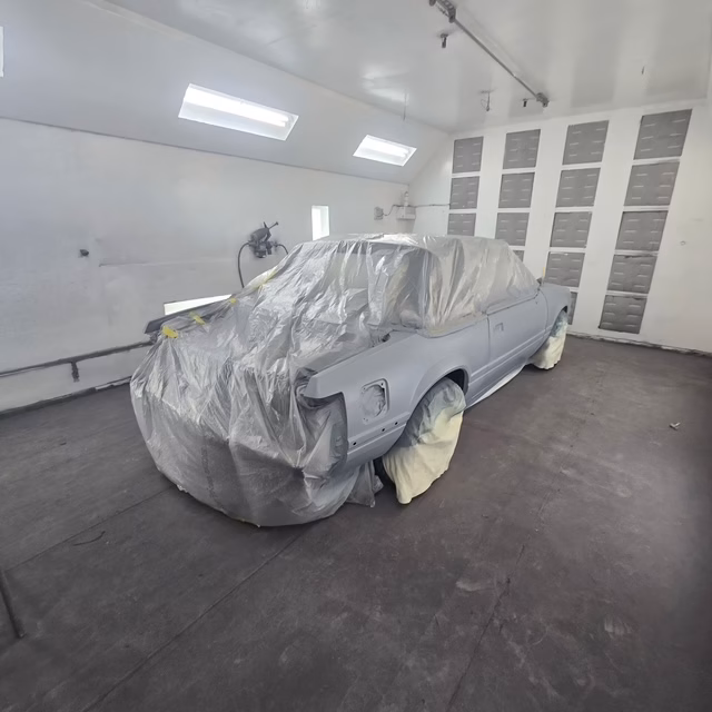 1987 Fox-body Mustang convertible shell staged in the paint booth at Rippers Body Shop, West Sacramento CA